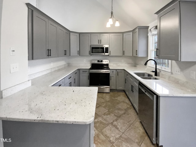 kitchen featuring stainless steel appliances, hanging light fixtures, sink, and gray cabinetry