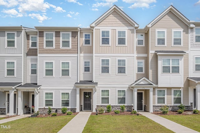 2708 Chert Ln, Raleigh, NC 27610 - townhome / multi-family property with stone siding and a front lawn