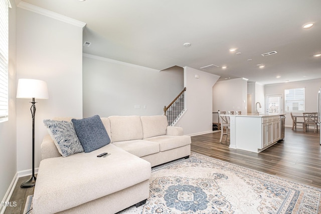2708 Chert Ln, Raleigh, NC 27610 - living room with ornamental molding, dark wood-style floors, recessed lighting, and stairs