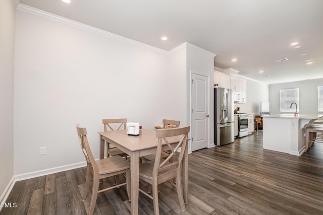 2708 Chert Ln, Raleigh, NC 27610 - dining space with dark wood finished floors, ornamental molding, and recessed lighting