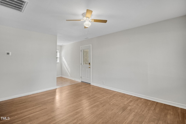 empty room with ceiling fan and light hardwood / wood-style flooring