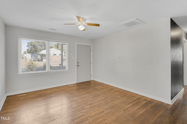 empty room with hardwood / wood-style flooring and ceiling fan