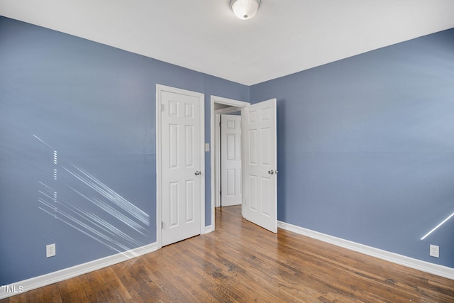 unfurnished bedroom featuring wood-type flooring