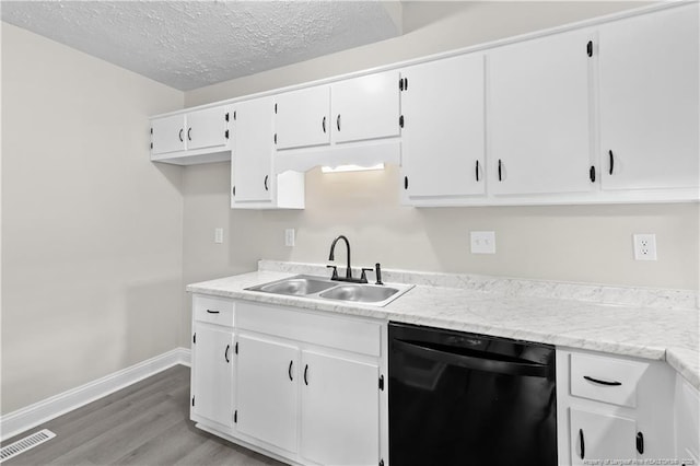 kitchen featuring sink, light hardwood / wood-style flooring, a textured ceiling, black dishwasher, and white cabinets