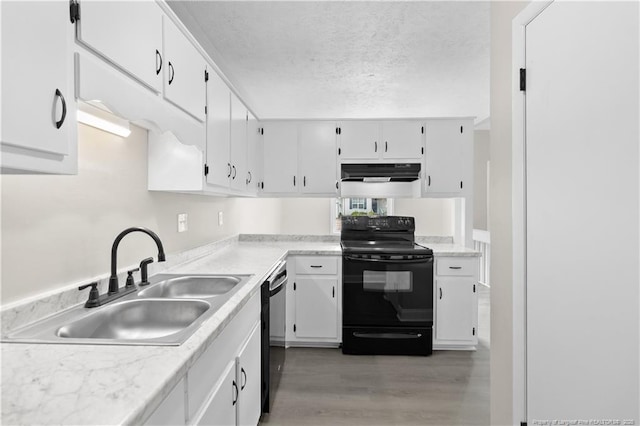 kitchen with white cabinetry, sink, light hardwood / wood-style floors, and black appliances