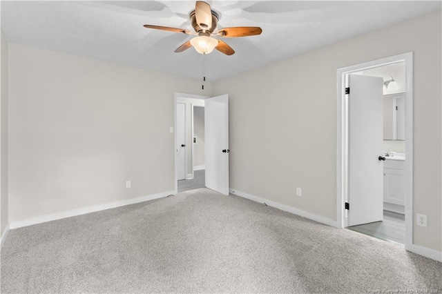 unfurnished bedroom featuring carpet flooring, ceiling fan, and ensuite bath