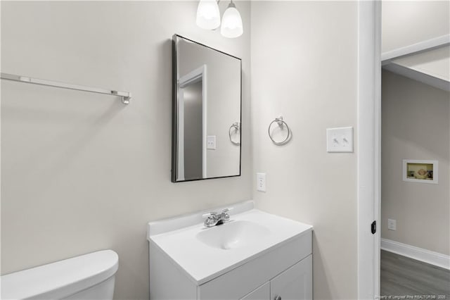 bathroom with vanity, hardwood / wood-style floors, and toilet