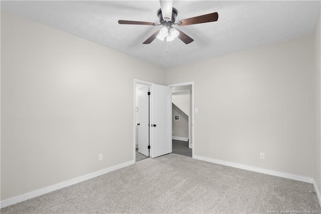 spare room with carpet and ceiling fan