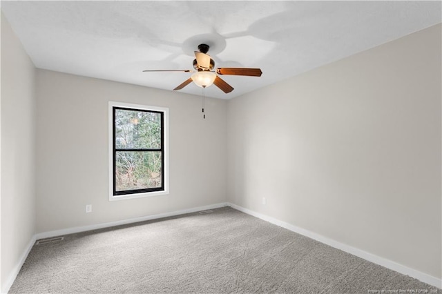 empty room with ceiling fan and carpet floors