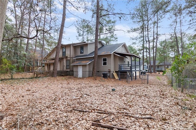 rear view of house featuring cooling unit