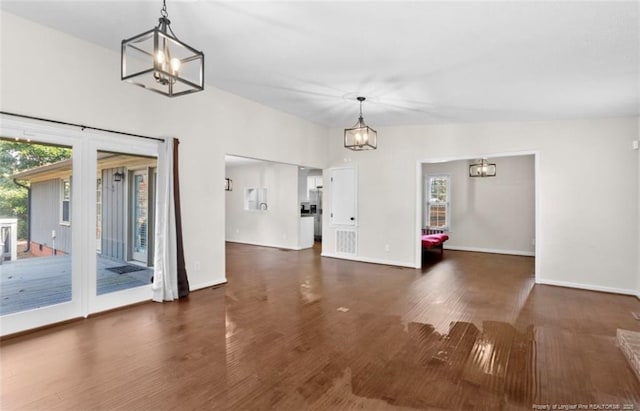 interior space featuring dark hardwood / wood-style flooring, a notable chandelier, and plenty of natural light