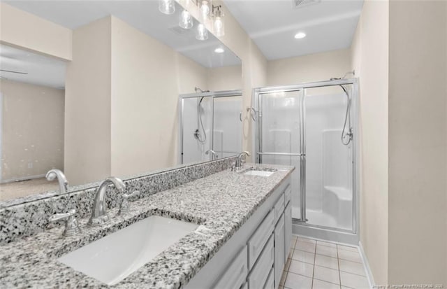 bathroom featuring tile patterned flooring, vanity, and an enclosed shower