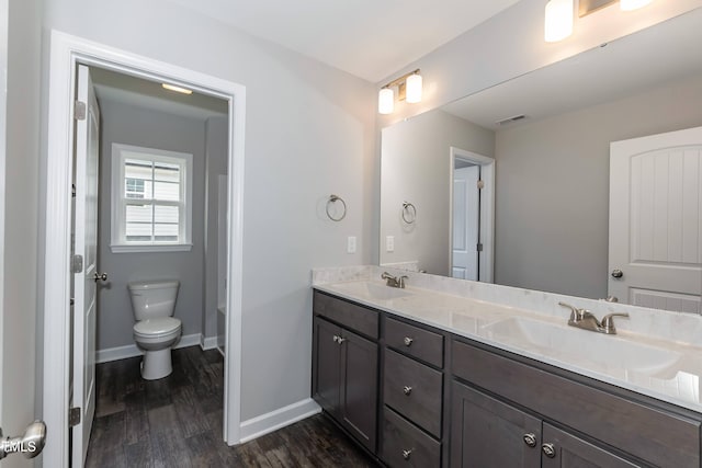 bathroom featuring vanity, toilet, and wood-type flooring