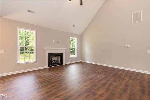 unfurnished living room with ceiling fan, dark hardwood / wood-style flooring, and high vaulted ceiling