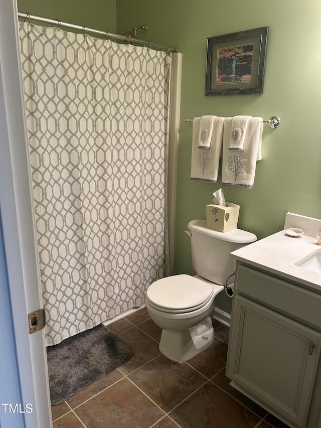 bathroom with vanity, tile patterned flooring, and toilet