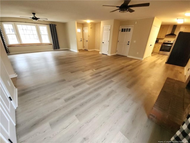 unfurnished living room with ceiling fan and light hardwood / wood-style floors