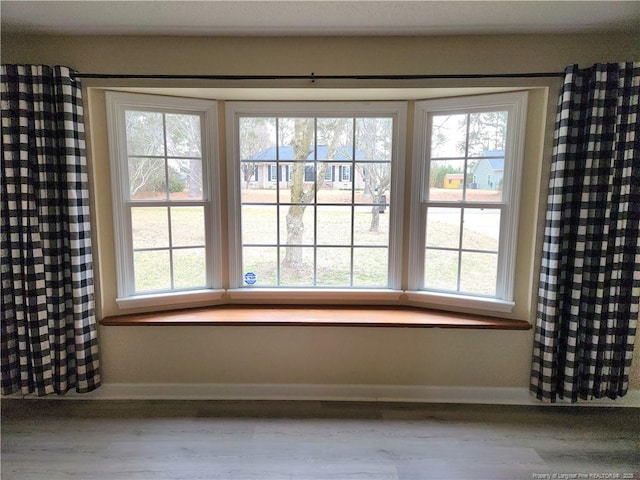 empty room with plenty of natural light and light wood-type flooring