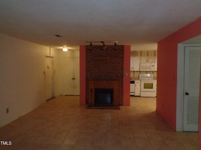 unfurnished living room featuring a brick fireplace