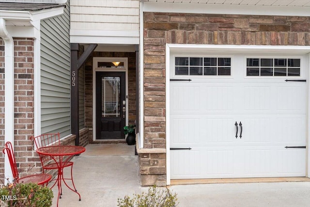 view of exterior entry with a garage