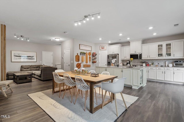 dining area with dark hardwood / wood-style floors