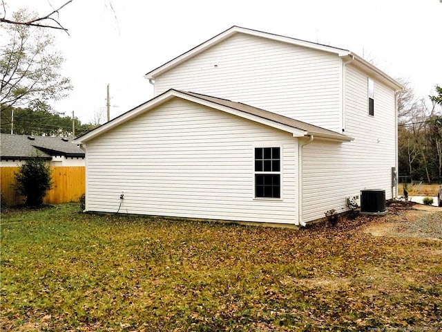 view of home's exterior featuring cooling unit and a yard