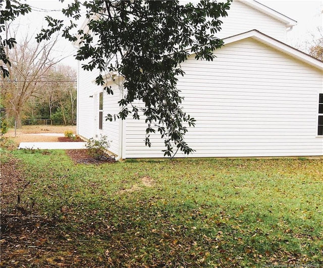 view of side of property with a yard