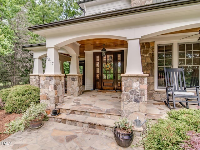 property entrance with stone siding and a porch