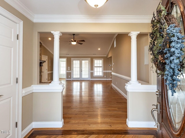 entryway with ornamental molding, decorative columns, and hardwood / wood-style floors