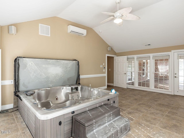 interior space featuring a wall mounted air conditioner, vaulted ceiling, and ceiling fan