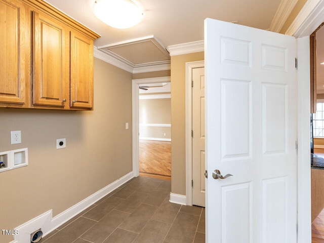 clothes washing area featuring crown molding, cabinets, washer hookup, dark tile patterned flooring, and hookup for an electric dryer