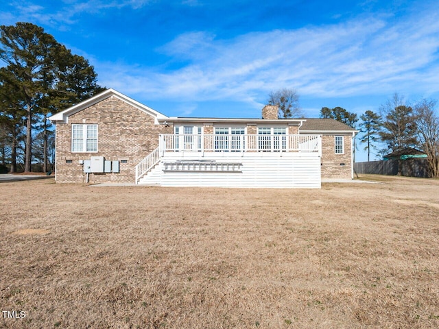 view of front of house with a front yard and a deck