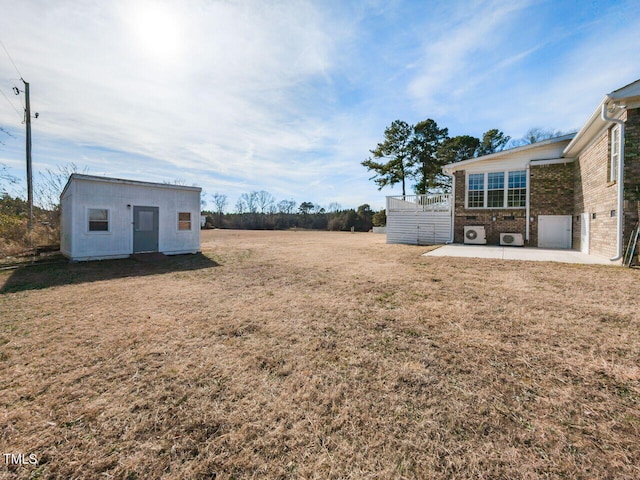 view of yard featuring an outbuilding and a patio