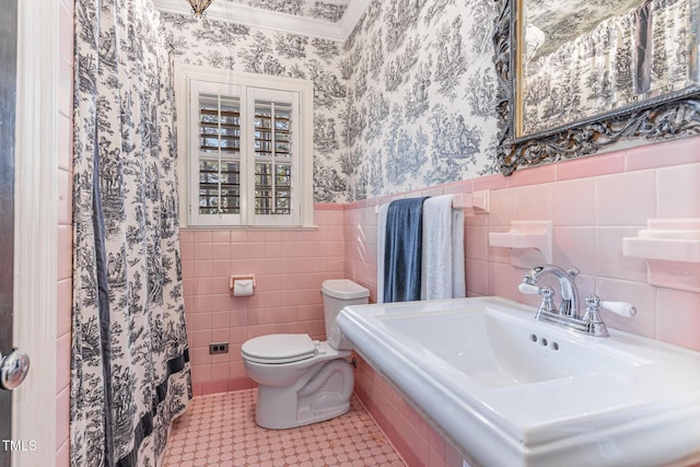 bathroom featuring sink, toilet, tile patterned flooring, and tile walls