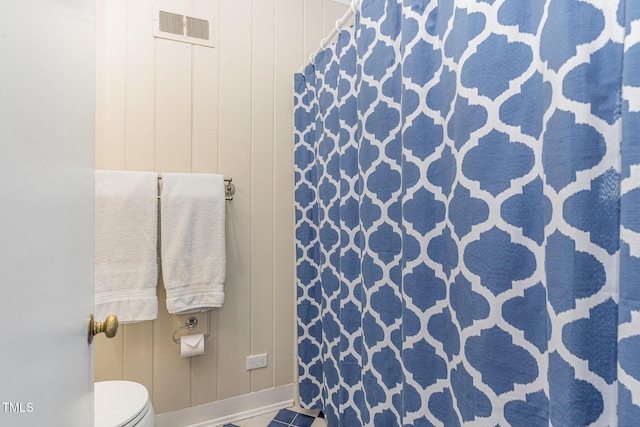 bathroom with tile patterned floors and toilet