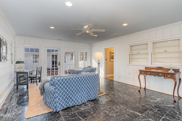 living room featuring crown molding and ceiling fan