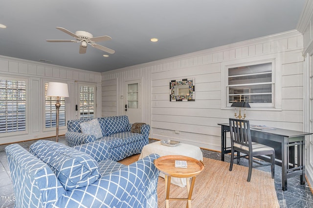 living room featuring crown molding and ceiling fan