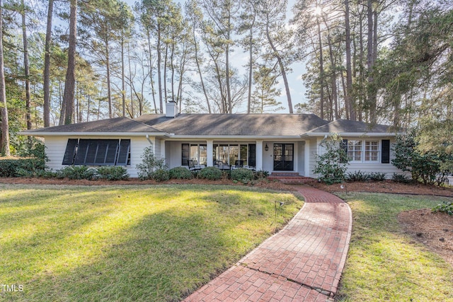 ranch-style home with a front yard and a porch