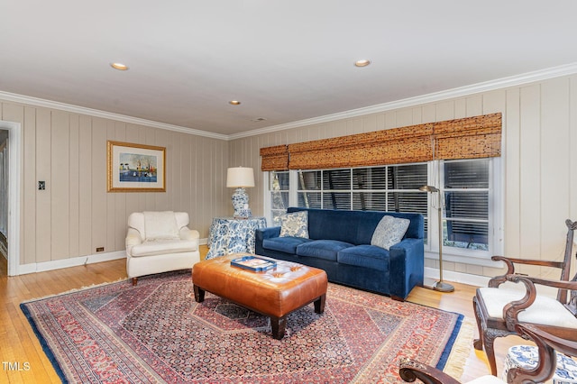 living room with hardwood / wood-style flooring and crown molding