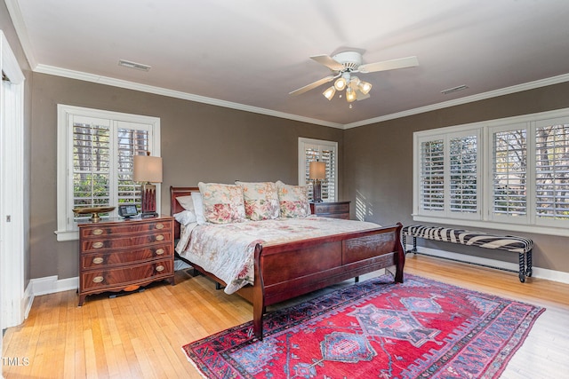 bedroom featuring hardwood / wood-style flooring, ceiling fan, and ornamental molding