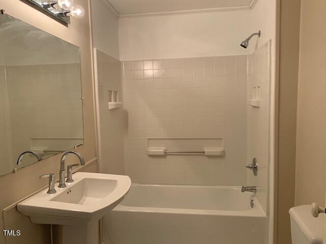 full bathroom featuring tiled shower / bath, crown molding, sink, and toilet