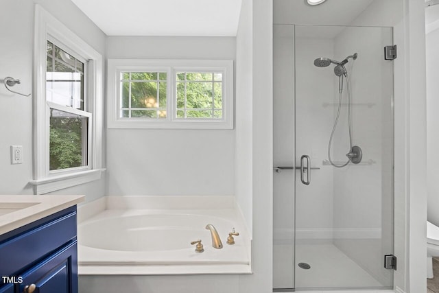 bathroom with vanity and plus walk in shower