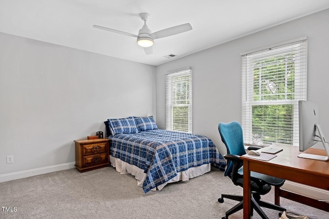 bedroom featuring ceiling fan, carpet floors, and multiple windows