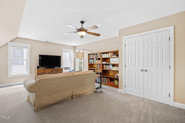 living room with lofted ceiling, carpet floors, and ceiling fan