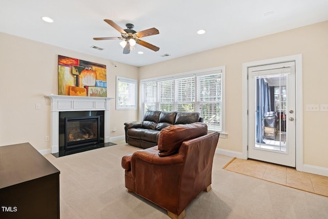 living room with light carpet and ceiling fan