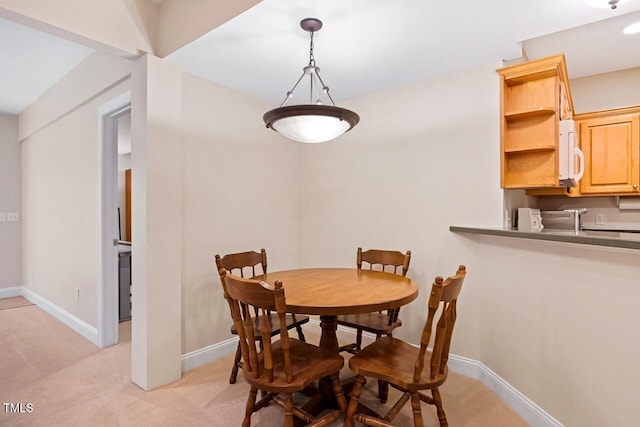 dining area with light colored carpet