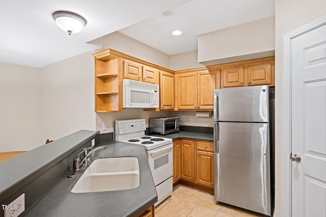 kitchen featuring light tile patterned flooring, sink, and white appliances