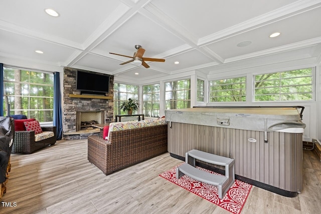 sunroom featuring beamed ceiling, plenty of natural light, coffered ceiling, and a jacuzzi