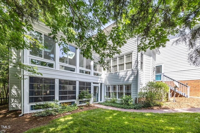 rear view of property with a yard