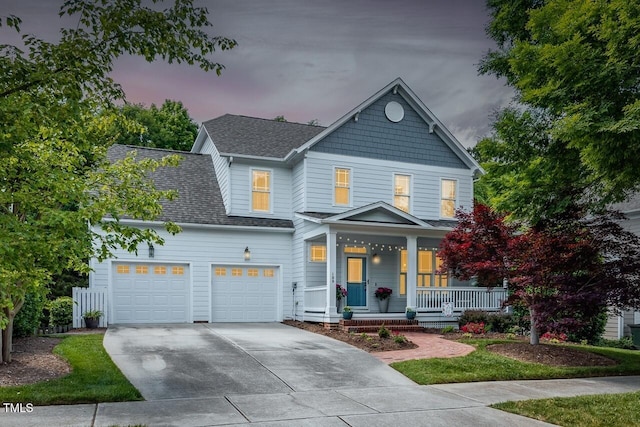 view of front of property featuring a garage and covered porch