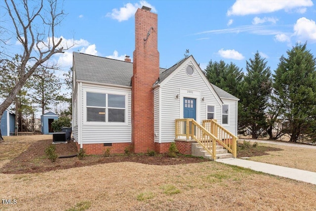 view of front facade with a front lawn and central air condition unit